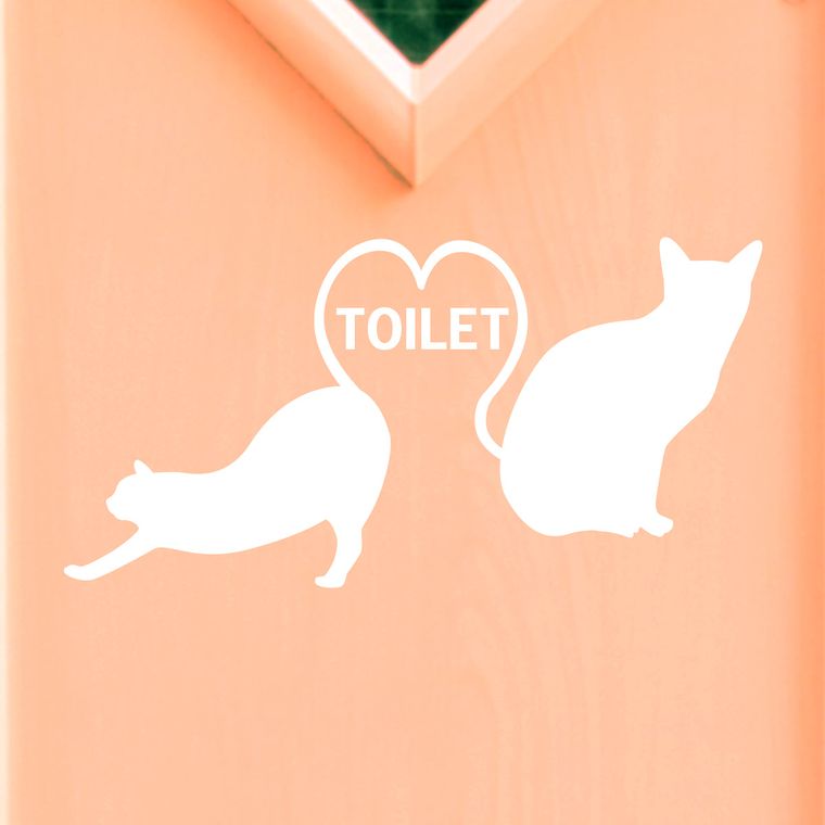 壁に貼られたねこのトイレサインの施工例